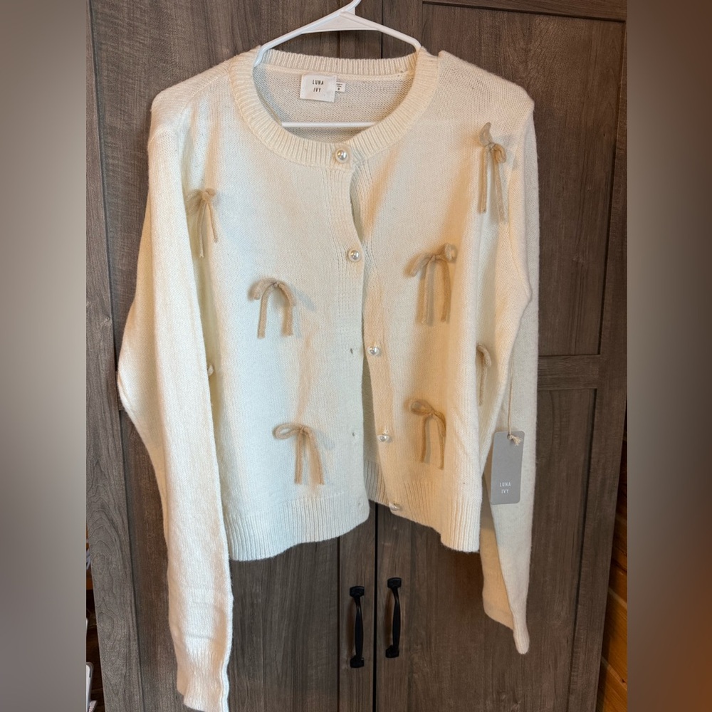 Luna Ivy bow sweater with pearl buttons. New with tags!